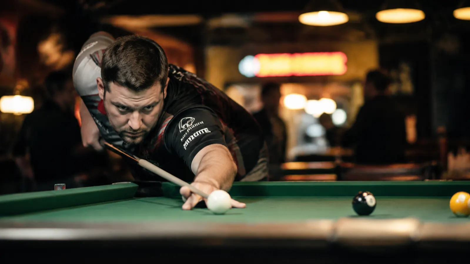 Pool player lining up a spin shot at a league night, focused expression
