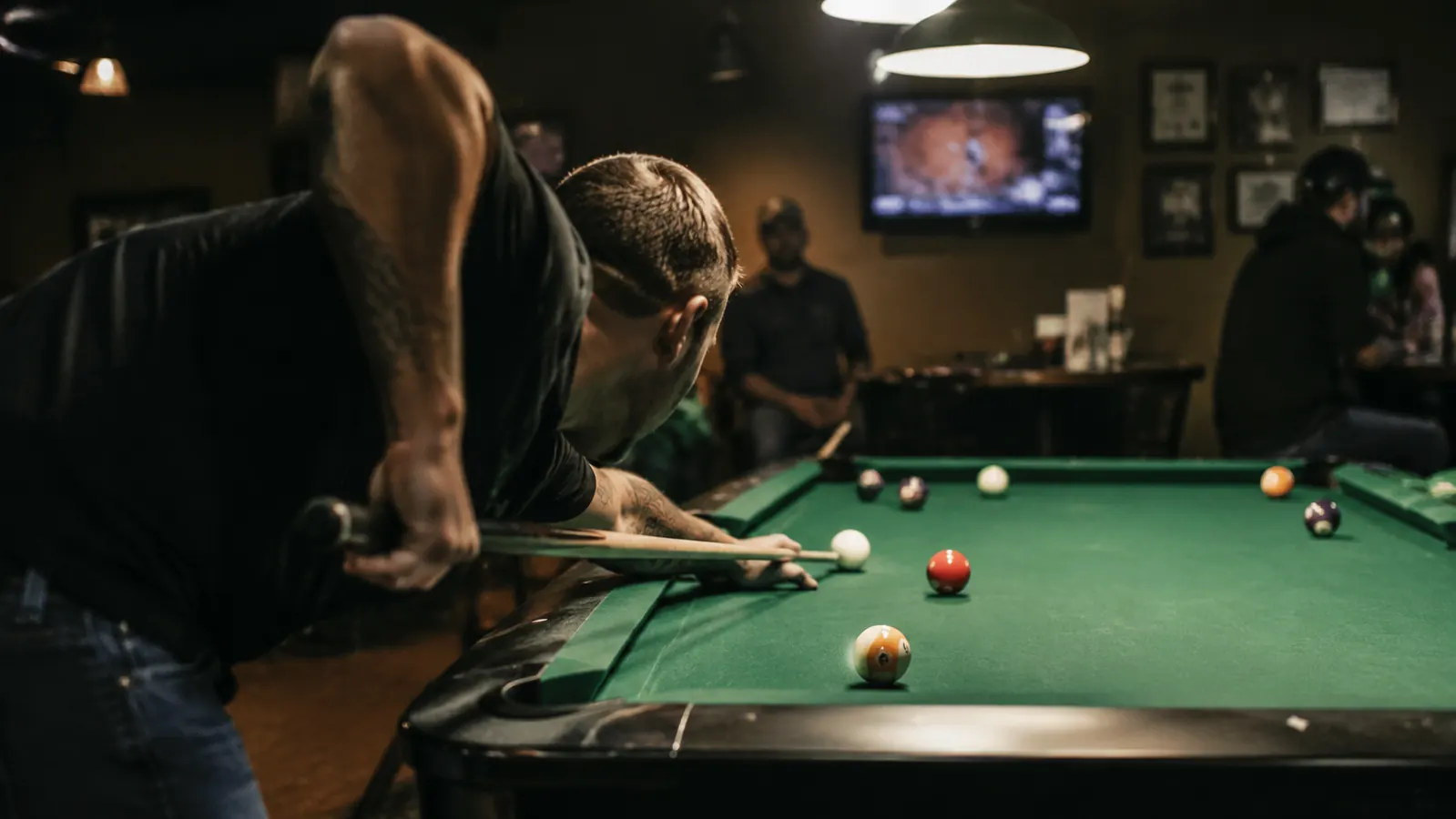 Pool player lining up a straight shot on a well-lit billiards table in a league setting