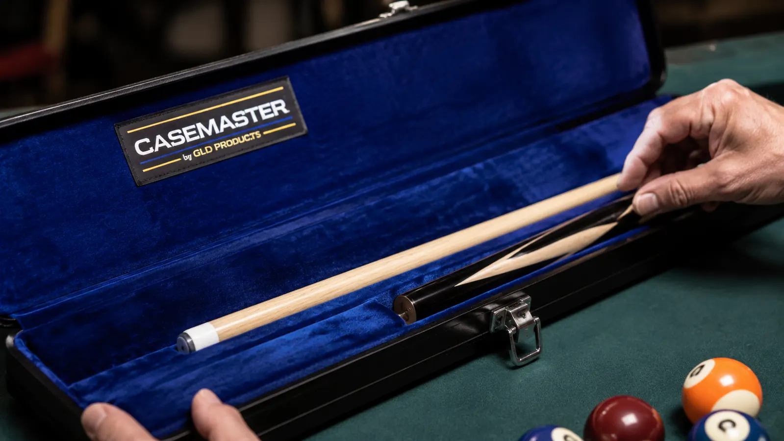 Interior view of the Q-Vault Supreme showing the blue velvet lining and cue shaft resting in the padded channel