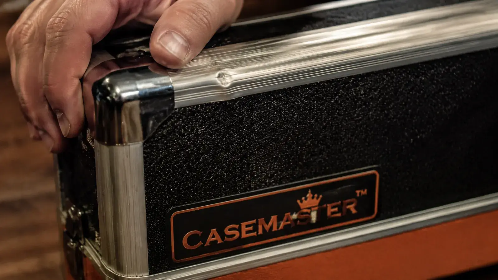 Close-up of aluminum rail and latch on Casemaster Q-Vault with small dent visible from impact