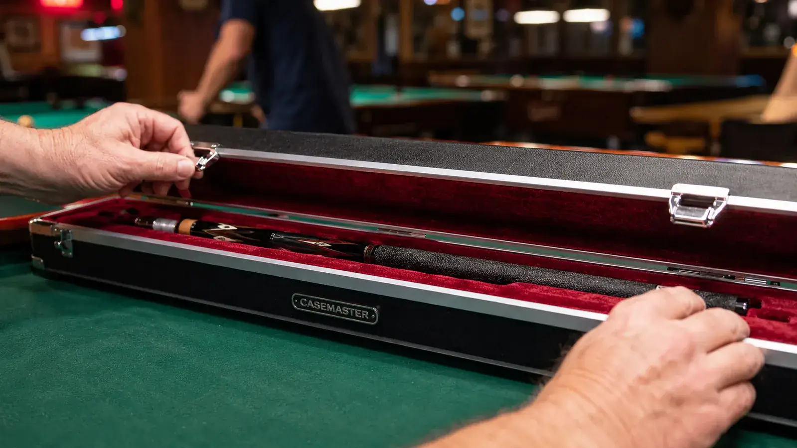 Hand opening the Casemaster Q-Vault Supreme case showing the velvet-lined interior and cue cradled inside
