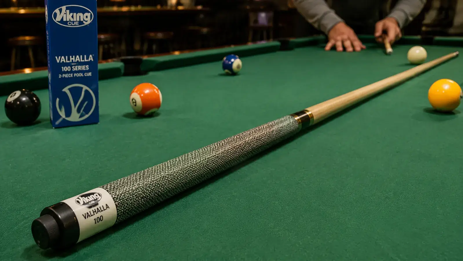 Viking Valhalla 100 Series pool cue laid across a green felt table