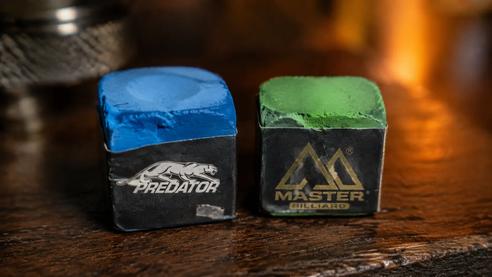 Two well-used chalk cubes after extended testing, showing wear patterns on Predator and Master cubes