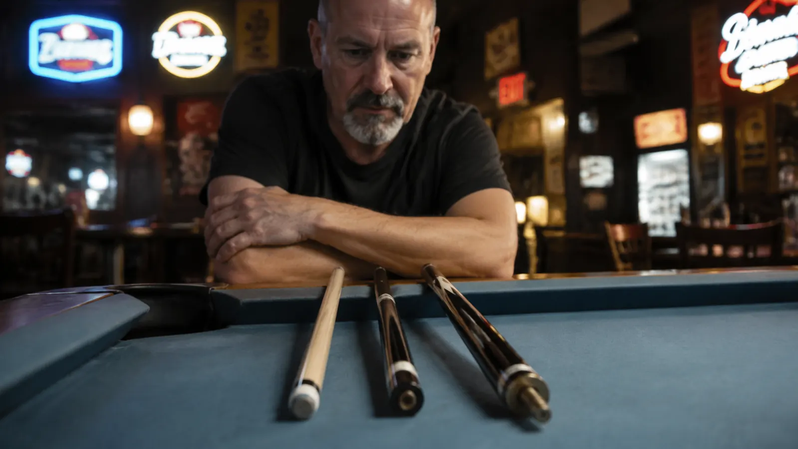 Player looking down at a pool table with disassembled break cue sections laid on the rail before screwing together