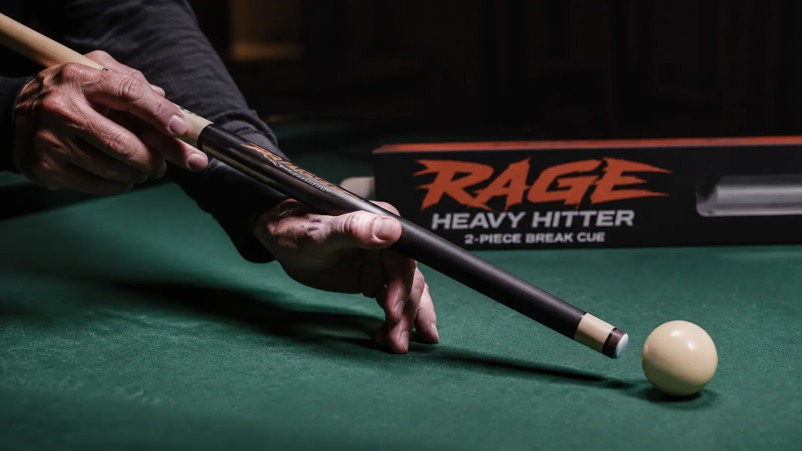 The RAGE Heavy Hitter in 2-piece jump configuration held at a steep angle over a cue ball on green felt