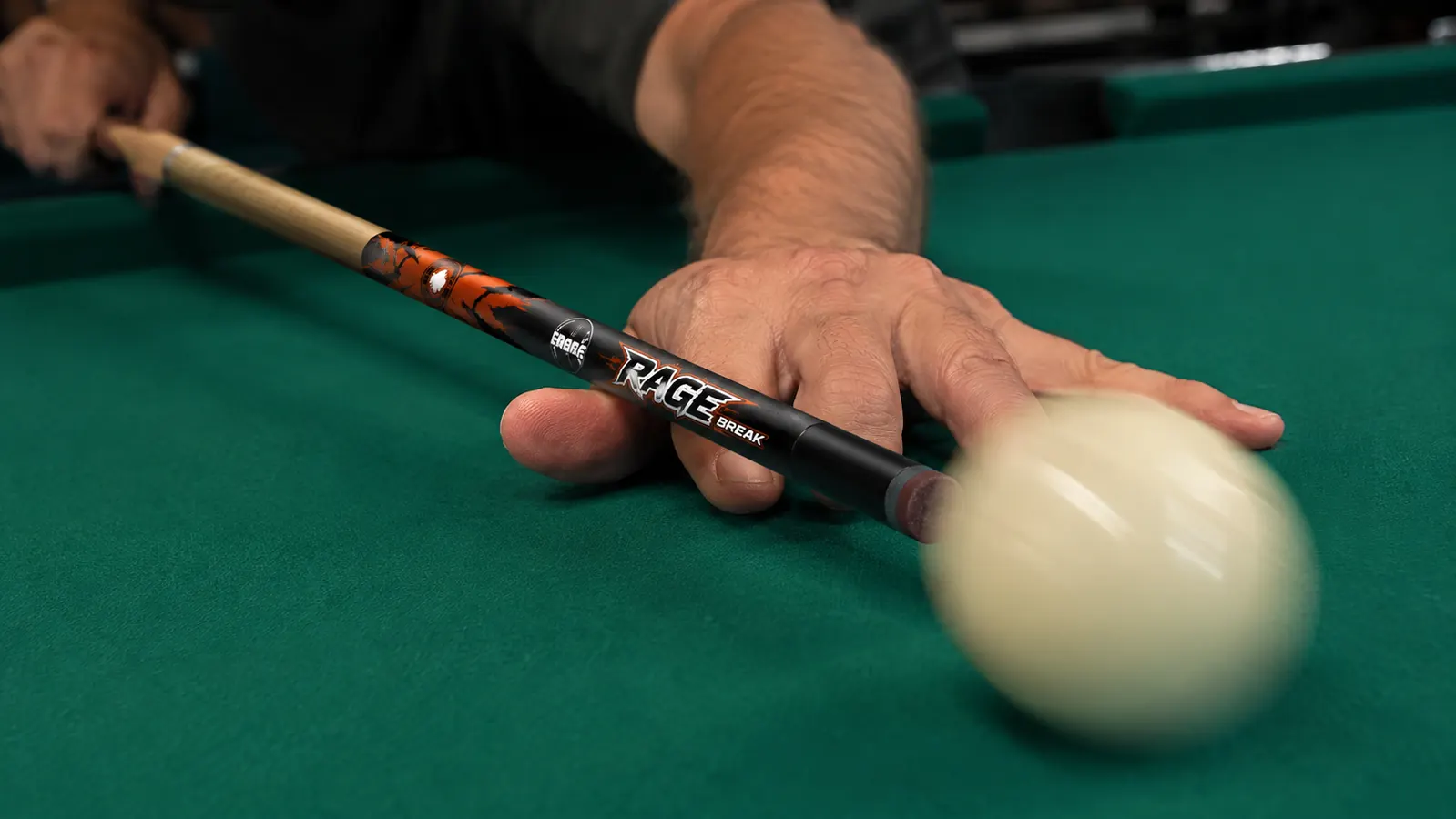 Close-up of a phenolic break cue tip making contact with a cue ball at the moment of a powerful break shot