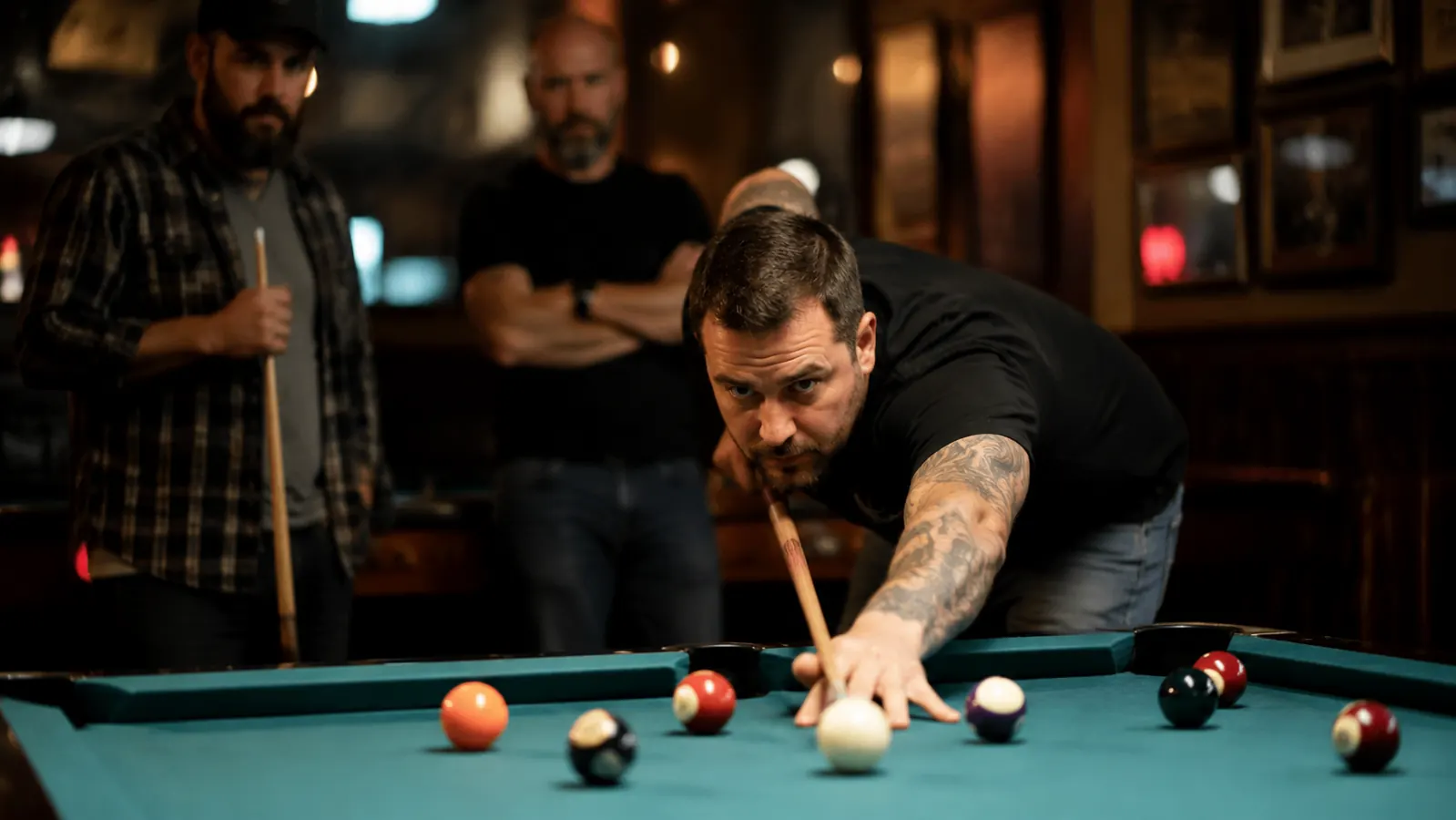 Pool player lining up a shot at a league night table under bar lighting